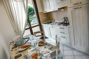 a kitchen with a table with plates of food on it at Villetta Tina in Vada