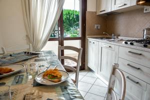 a kitchen with a table with a plate of food on it at Villetta Tina in Vada