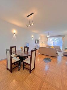 a living room with a table and a couch at Luxury 4 BR Homely Apt with a pool in Kisumu