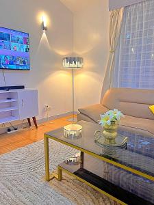 a living room with a couch and a coffee table at Luxury 4 BR Homely Apt with a pool in Kisumu