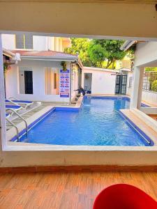 a large swimming pool in front of a house at Luxury 4 BR Homely Apt with a pool in Kisumu