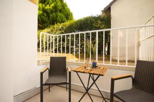 a patio with two chairs and a table on a balcony at Appartement eleven in Duisburg