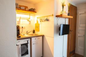 a small kitchen with a sink and a refrigerator at Appartement eleven in Duisburg