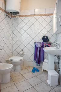 a bathroom with a toilet and a sink at Villetta Tina in Vada +37 photos