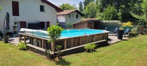 a swimming pool in a yard next to a house at Maison familiale in Bidart