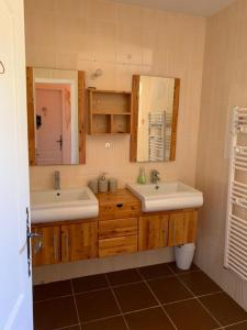 a bathroom with two sinks and a mirror at La Luberonne gordes in Gordes +39 photos