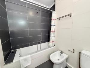 a bathroom with a white toilet and a sink at Perez del Molino - 5806 in Isla