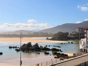 a beach with a bunch of elephants in the water at Perez del Molino - 5806 in Isla +9 photos