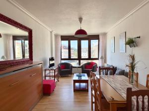 a kitchen and living room with a table and chairs at Perez del Molino - 5806 in Isla