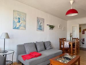 a living room with a gray couch and a table at Perez del Molino - 5806 in Isla