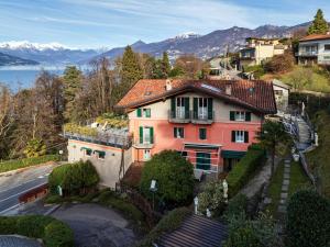 a house on a hill with a lake and mountains at Bellagio Bed & Breakfast in Bellagio