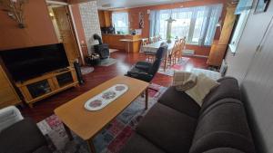 a living room with a couch and a table at Tromtind Lodge in Tromsø
