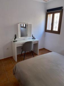 a bedroom with a desk and a bed and a window at Casa Amigos Rural in Cuevas del Almanzora +37 photos