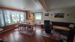 a living room with a table and a couch at Tromtind Lodge in Tromsø