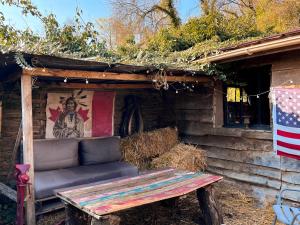 a bench sitting outside of a house with a flag at La Cabane Aux Loups in Crépy-en-Valois