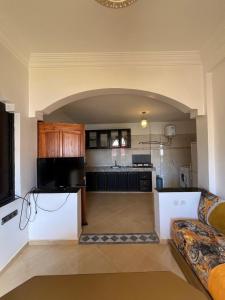a living room with a couch and a kitchen at Tamraght Sunny apartment in Tamraght Ouzdar