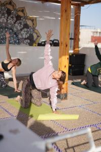 a group of people doing yoga in a gym at Tamraght Sunny apartment in Tamraght Ouzdar