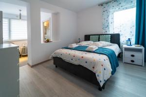 a bedroom with a bed with polka dots on it at Vila Petro in Iaşi