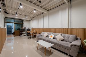 a living room with a couch and a table at Cool cozy In Yaowarat in Bangkok