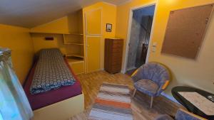 a small room with a bunk bed and a chair at Tromtind Lodge in Tromsø