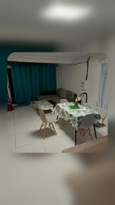 a living room with a table and chairs and a couch at Ti case ali in Saint-Benoît