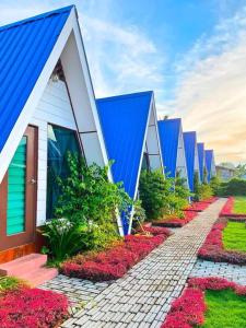 a row of houses with flowers in front of them at Hosanna village in Semporna