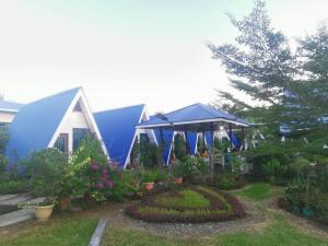 a garden with a house with a gazebo at Hosanna village in Semporna