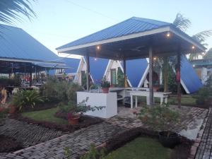 a house with a blue roof with a picnic table at Hosanna village in Semporna