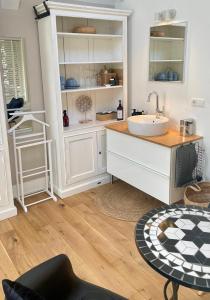 a bathroom with a sink and a counter at Prins Heerlijk in Sassenheim +14 photos