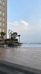 a parking lot with trees in front of a building at Sorici Studio at Bella Tower in Surabaya