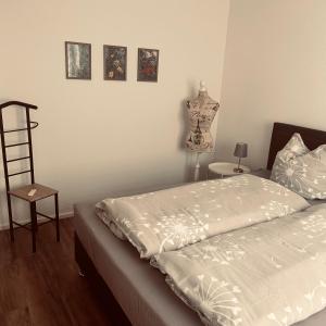 a bedroom with a bed and a dresser and a dummy at Ferienwohnung Schwarzwaldrand in Nagold