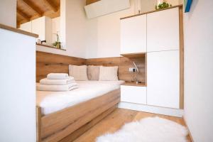 a small bedroom with a bed and a mirror at Tyrolschalet LITTLE LUCK - Private Pool & Mountain View in Rofansiedlung