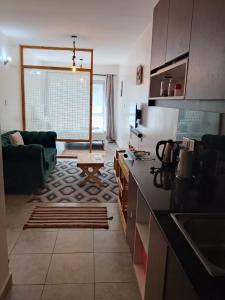 a kitchen and living room with a couch and a table at Bohen BnB 1 in Ongata Rongai 