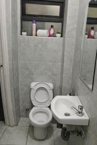 a bathroom with a toilet and a sink at Bohen BnB 1 in Ongata Rongai 