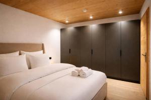 a bedroom with a bed with two towels on it at RACING Suite - Terrace & Sauna Access in Kleinboden +23 photos