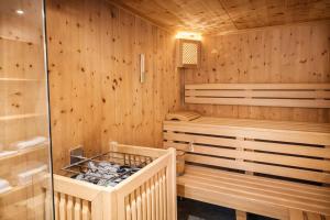 a sauna with wooden paneled walls and a shower at RACING Suite - Terrace & Sauna Access in Kleinboden