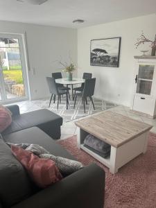 a living room with a couch and a table at Ferienwohnung Schwarzwaldrand in Nagold