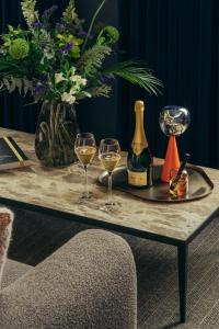 ein Tisch mit zwei Gläsern Wein und einer Flasche Champagner in der Unterkunft Lyla Rooms in Edinburgh