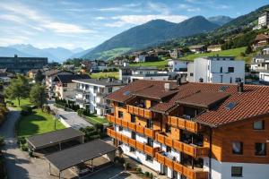 a city with buildings and mountains in the background at OLDWOOD CHALET - Design Chalet & Balcony in Fügen