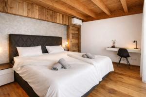 a bedroom with a large bed with two pillows on it at CLOUD 9 - Private Whirlpool & Rooftop Terrace in Fügen