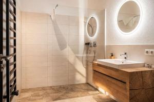 a bathroom with a sink and a shower at CHEZ NOUS - Balcony & Mountain View in Fügen