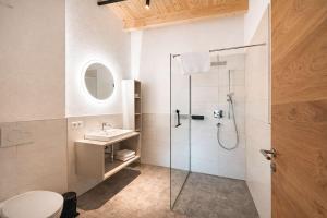 a bathroom with a shower and a sink at ViVaZILARE - Design Loft with Terrace in Fügen