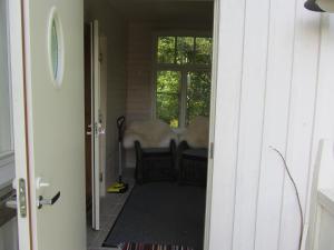 an open door to a room with a table and chairs at Willa Tapala in Matildedal
