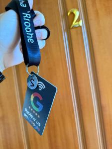 a person holding a key tag on a door at Vila Rrodhe in Durrës +9 photos