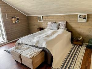 a bedroom with a large bed in a room at Unique boathouse with a spectacular view in Oldra