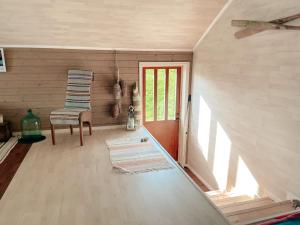 a living room with a chair and a door at Unique boathouse with a spectacular view in Oldra +9 photos