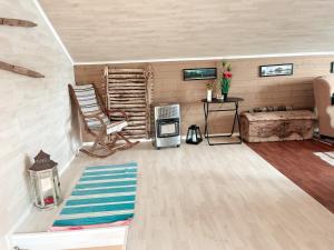 a living room with a couch and a chair at Unique boathouse with a spectacular view in Oldra