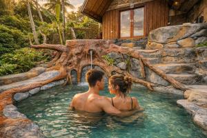 a man and a woman sitting in a hot tub at Vana Nugraha Villas in Tampaksiring +18 photos