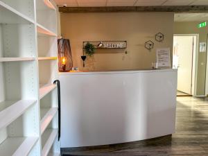 a white counter in a room with shelves at Við Hafið Oceanfront Guesthouse in Ólafsvík