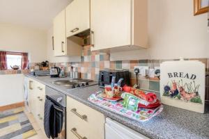 a kitchen counter with a tray of food on it at Wolds View in Cornisholme +31 photos